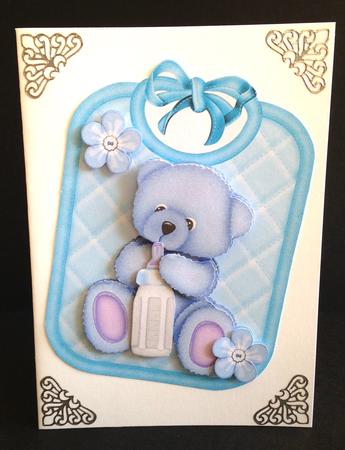 Gorgeous Little Blue Bear on a Bib Holding a Bottle by Ulla Skraedderdal
