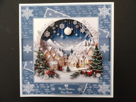 8 x 8 papercut village quick card front (Blue). by Valerie Spowart