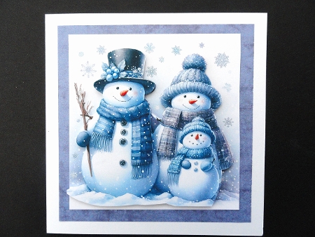 NEW STORY CARD. Smiling snowman family cuddles together as gentle snowflakes fall softly. by Valerie Spowart