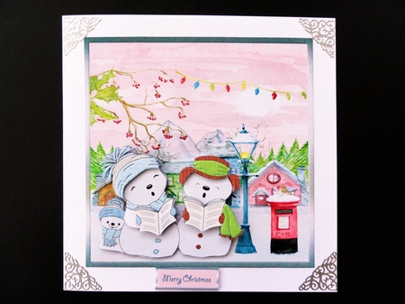 Snowman carol singers is a 7x7 card with decoupage by Valerie Spowart