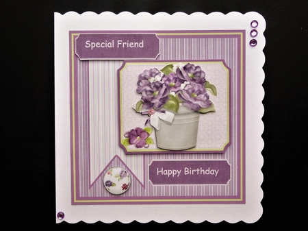 Pot of violet flowers by Valerie Spowart