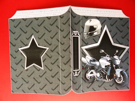 Motorbike with Helmet on Folded Book by Valerie Spowart