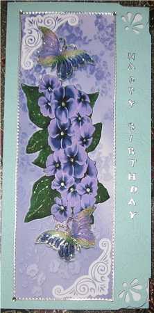 Pretty lilac flowers in ornate lace Tall Dl with butterflies by Wendy De Winter