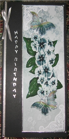 Pretty silver flowers in ornate lace Tall Dl with butterflies by Wendy De Winter
