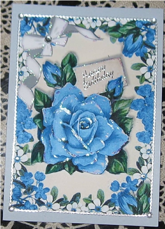 Pretty blue roses with diamante bow in flower frame by Wendy De Winter