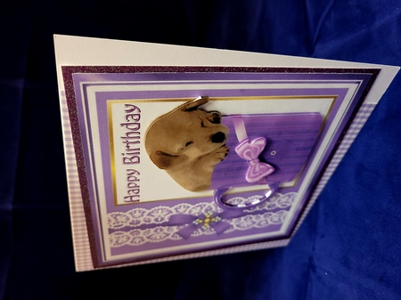 Cute little puppy sleeping in a mug with purple bow 8x8 by Yana Pritchard