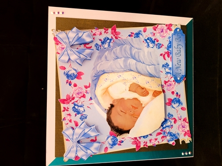Sweet little sleeping ethnic baby boy in floral frame by Yana Pritchard