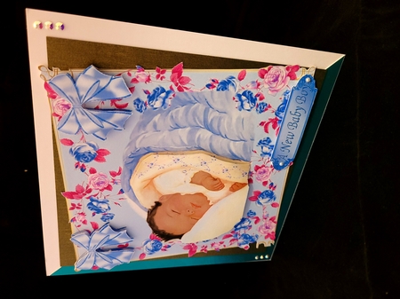 Sweet little sleeping ethnic baby boy in floral frame by Yana Pritchard