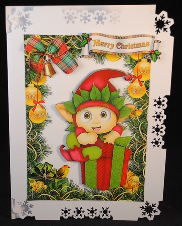 Cheeky santa elf sitting on present in christmas frame by Yvonne Middleton
