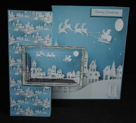 Santa in flight over the town by Yvonne Middleton