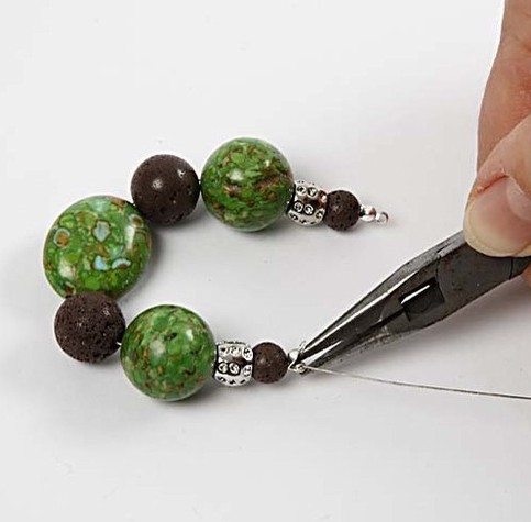 A bracelet with stone beads and lava beads.