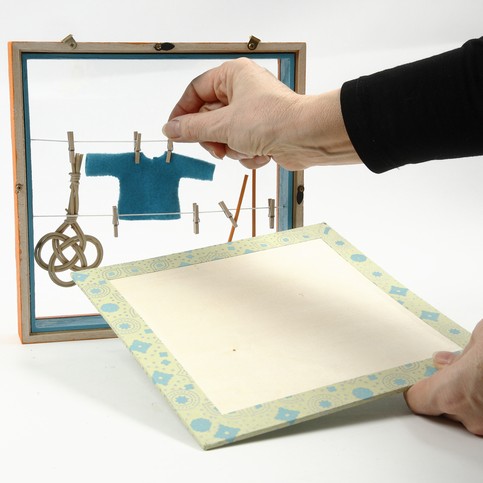 A Framed Box with Clothes Lines