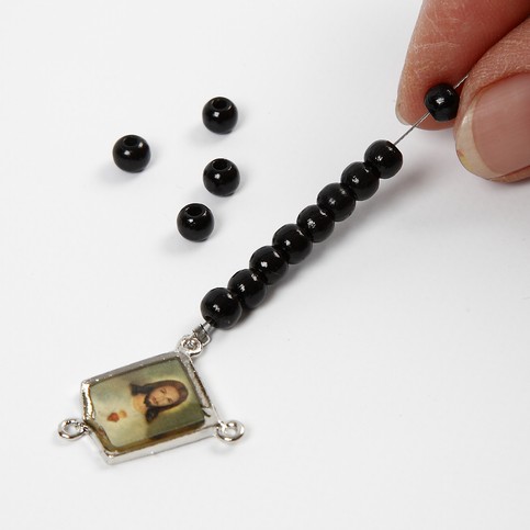 A Pendant of Christ with Wooden Beads