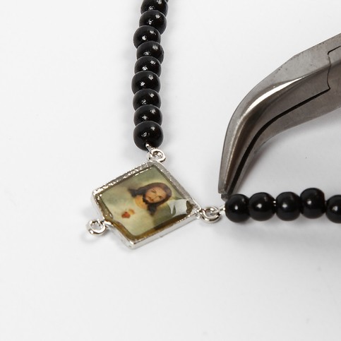 A Pendant of Christ with Wooden Beads