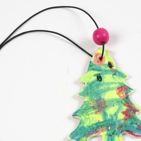 A Wooden Hanging Decoration painted with Oil Pastels
