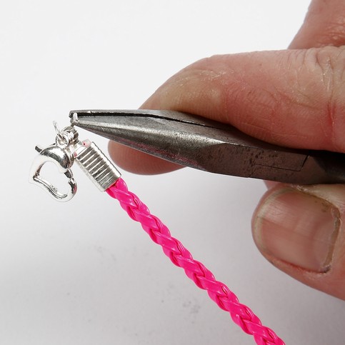 A Neon-Coloured Plaited Bracelet with a Pendant