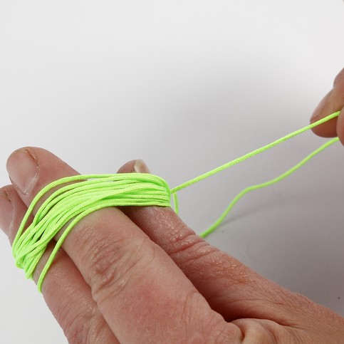 A Neon-Coloured Plaited Bracelet with a Pendant