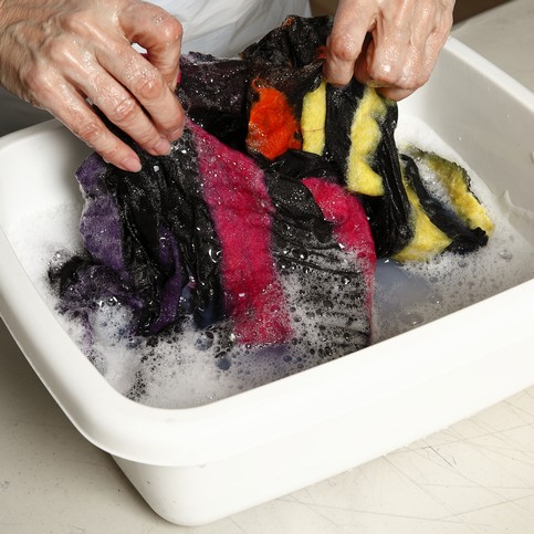 A Black Scarf with colourful Felt Stripes