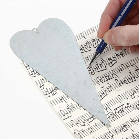 A Metal Heart decorated with Music Notes Kraft Paper and an Angel