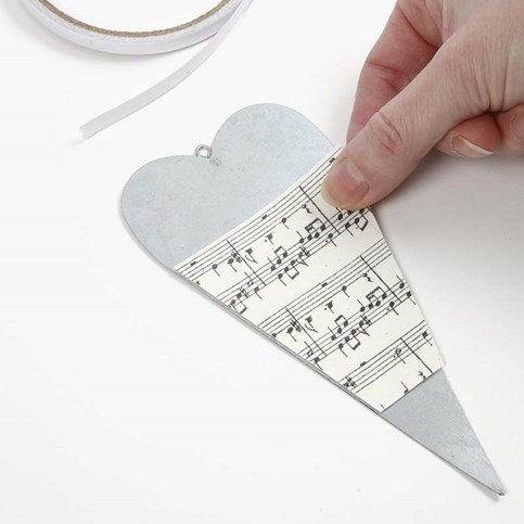 A Metal Heart decorated with Music Notes Kraft Paper and an Angel