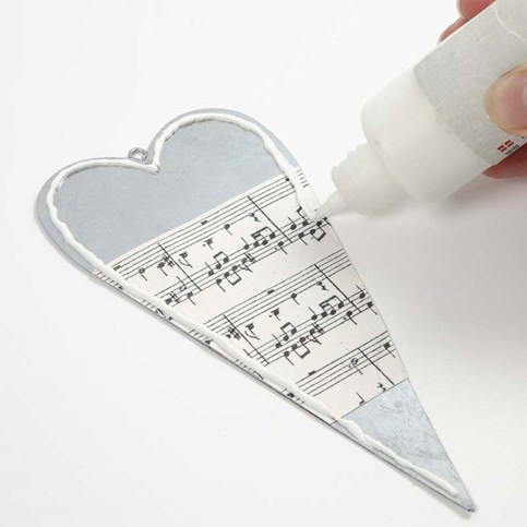 A Metal Heart decorated with Music Notes Kraft Paper and an Angel