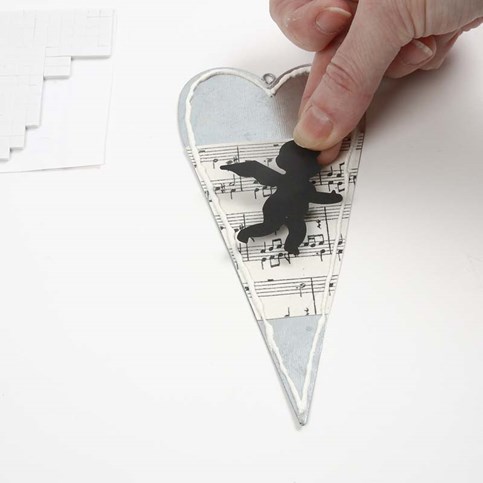 A Metal Heart decorated with Music Notes Kraft Paper and an Angel