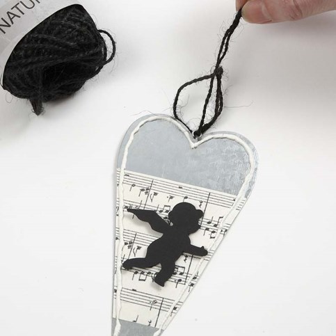 A Metal Heart decorated with Music Notes Kraft Paper and an Angel
