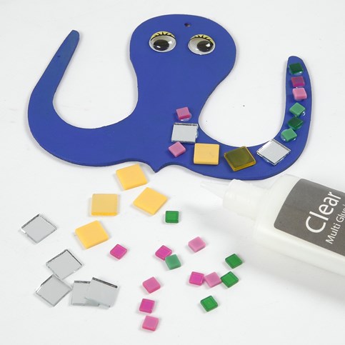 A flat wooden decorative Shape – painted and decorated with Mosaics