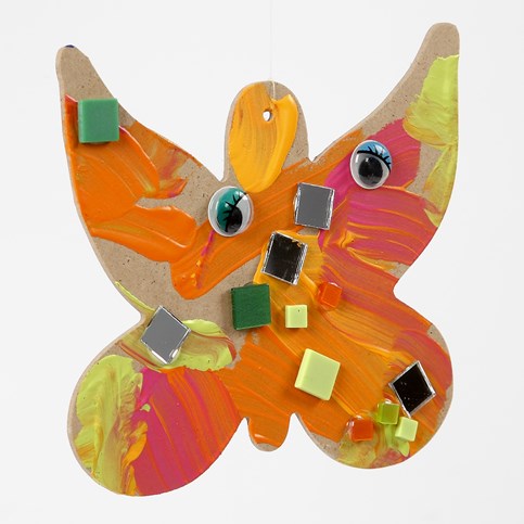 A flat wooden decorative Shape – painted and decorated with Mosaics