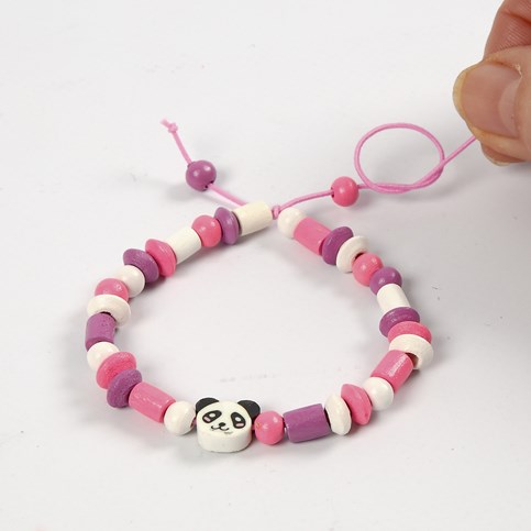 A Bracelet made from coloured Elastic Cord with a Shaped Wooden Bead and Wooden Beads