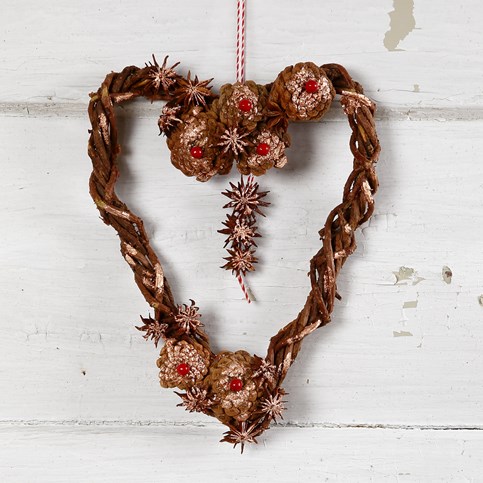 A woven heart-shaped Garland made from natural Branches with Cones and Star Anise