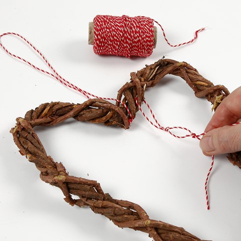 A woven heart-shaped Garland made from natural Branches with Cones and Star Anise