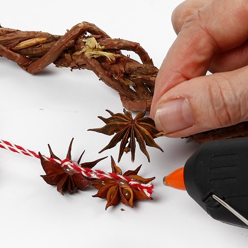 A woven heart-shaped Garland made from natural Branches with Cones and Star Anise