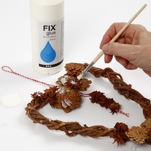 A woven heart-shaped Garland made from natural Branches with Cones and Star Anise