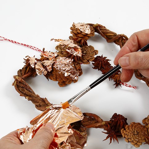 A woven heart-shaped Garland made from natural Branches with Cones and Star Anise