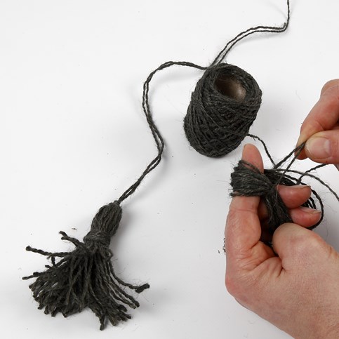 An Advent Wreath with Tassels and Metal Tags with Numbers