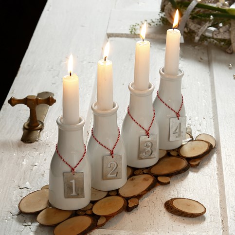 An Advent Candle Holder made from Milk Bottles with numbered Zinc Tags