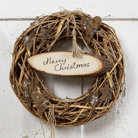 A Front Door Garland with a Sign, Bark Decorations and a natural Hemp Pom-Pom