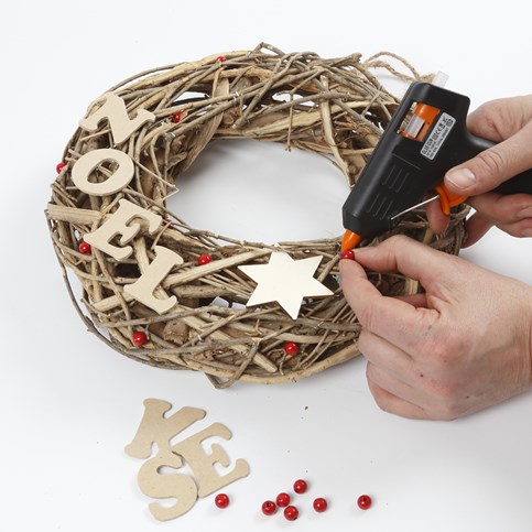 A Garland made from natural Twigs with wooden Decorations and a Bow