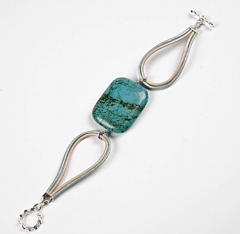 A bracelet with a large turquoise stone bead